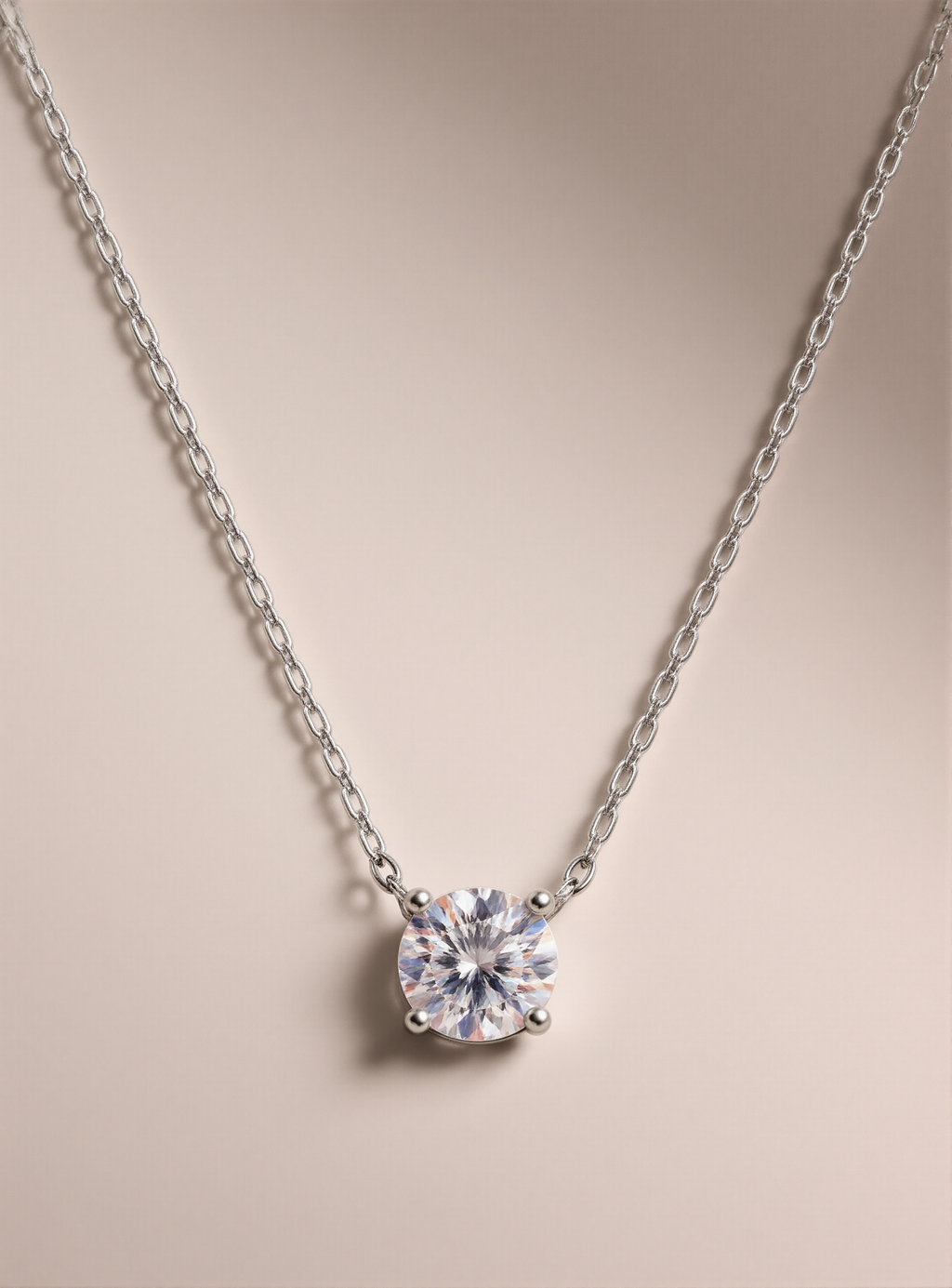 Silver necklace with a round moissanite pendant on a beige background