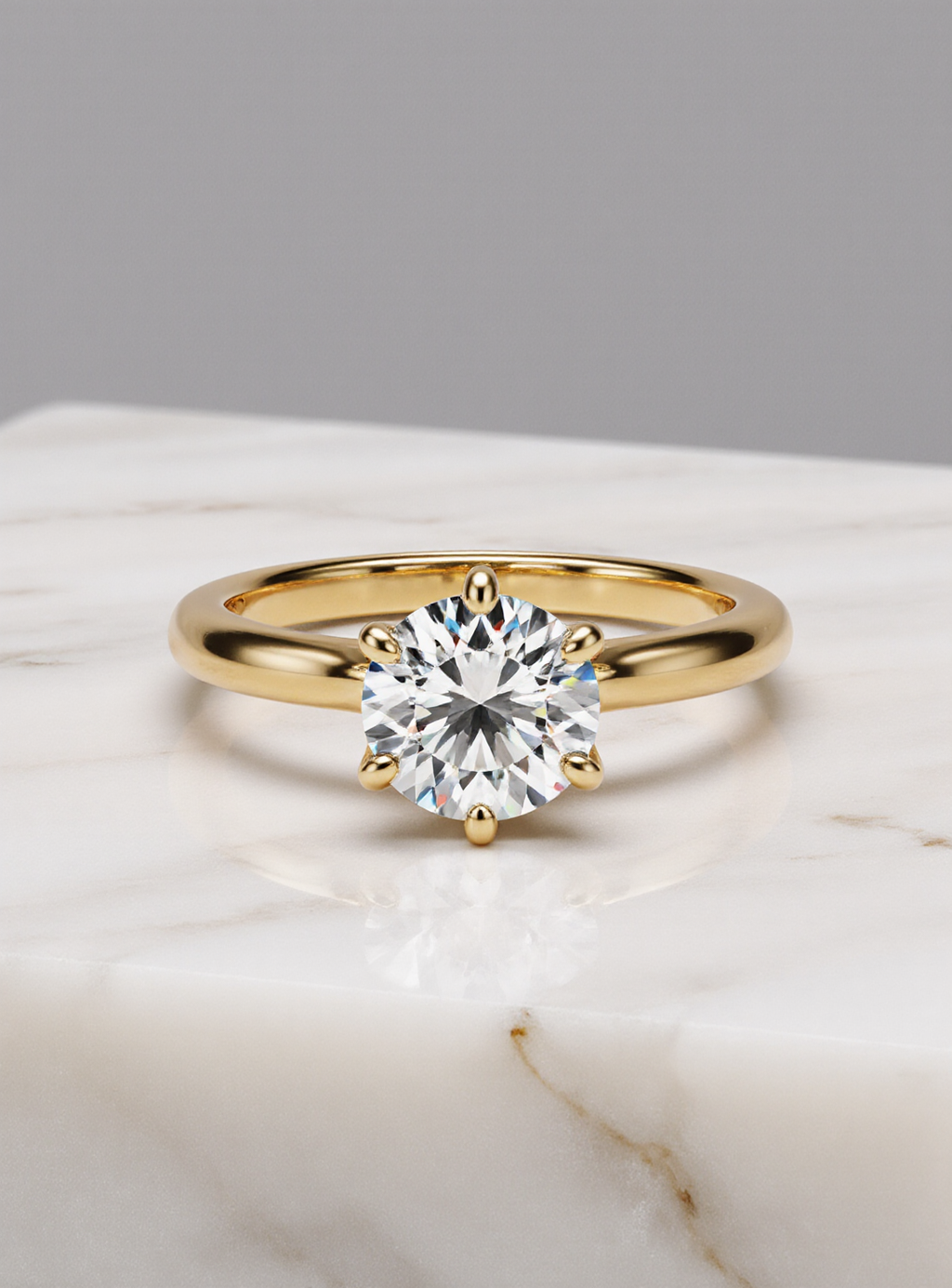 Gold ring with a large moissanite on a marble surface